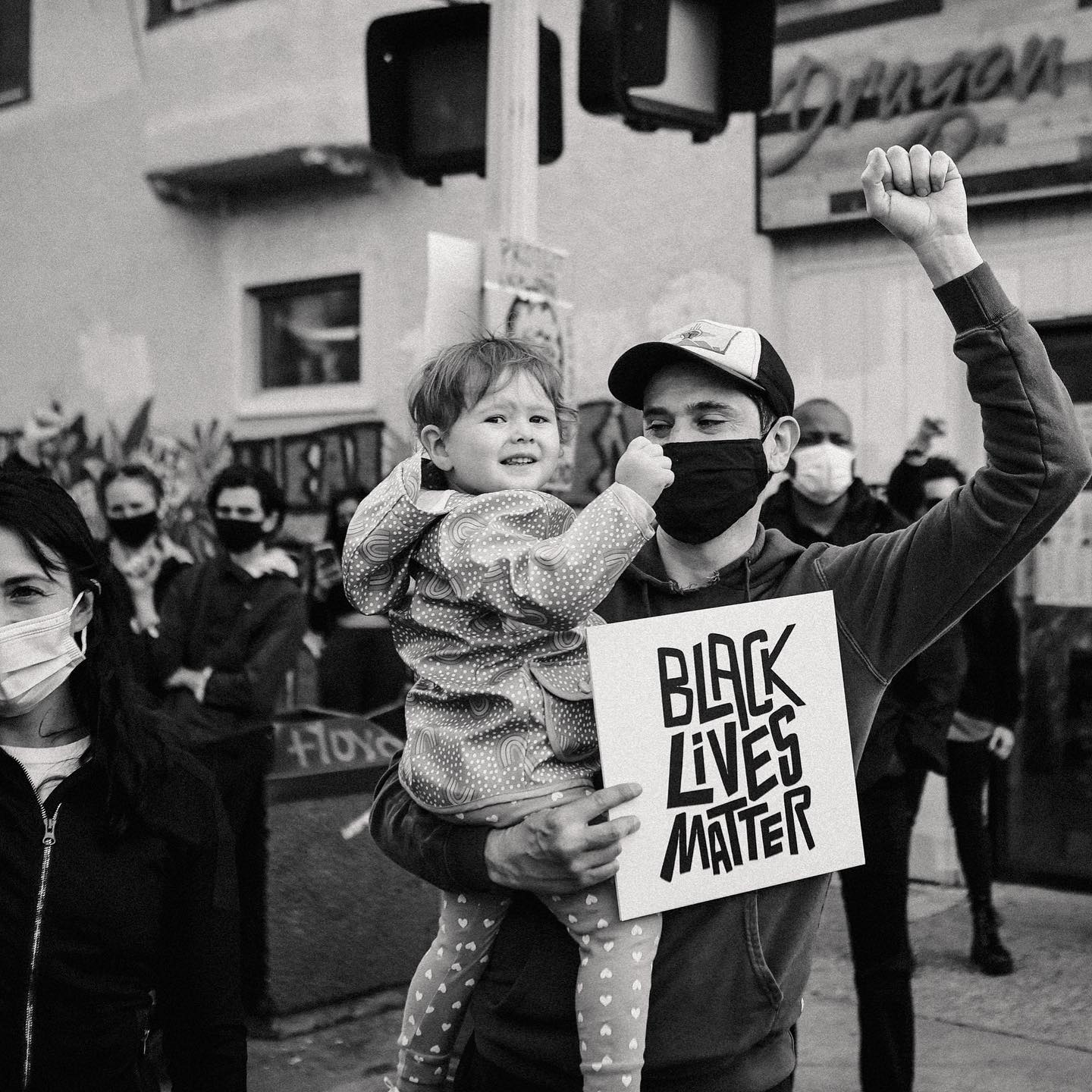 Photo of man and child holding Black Lives Matter sign