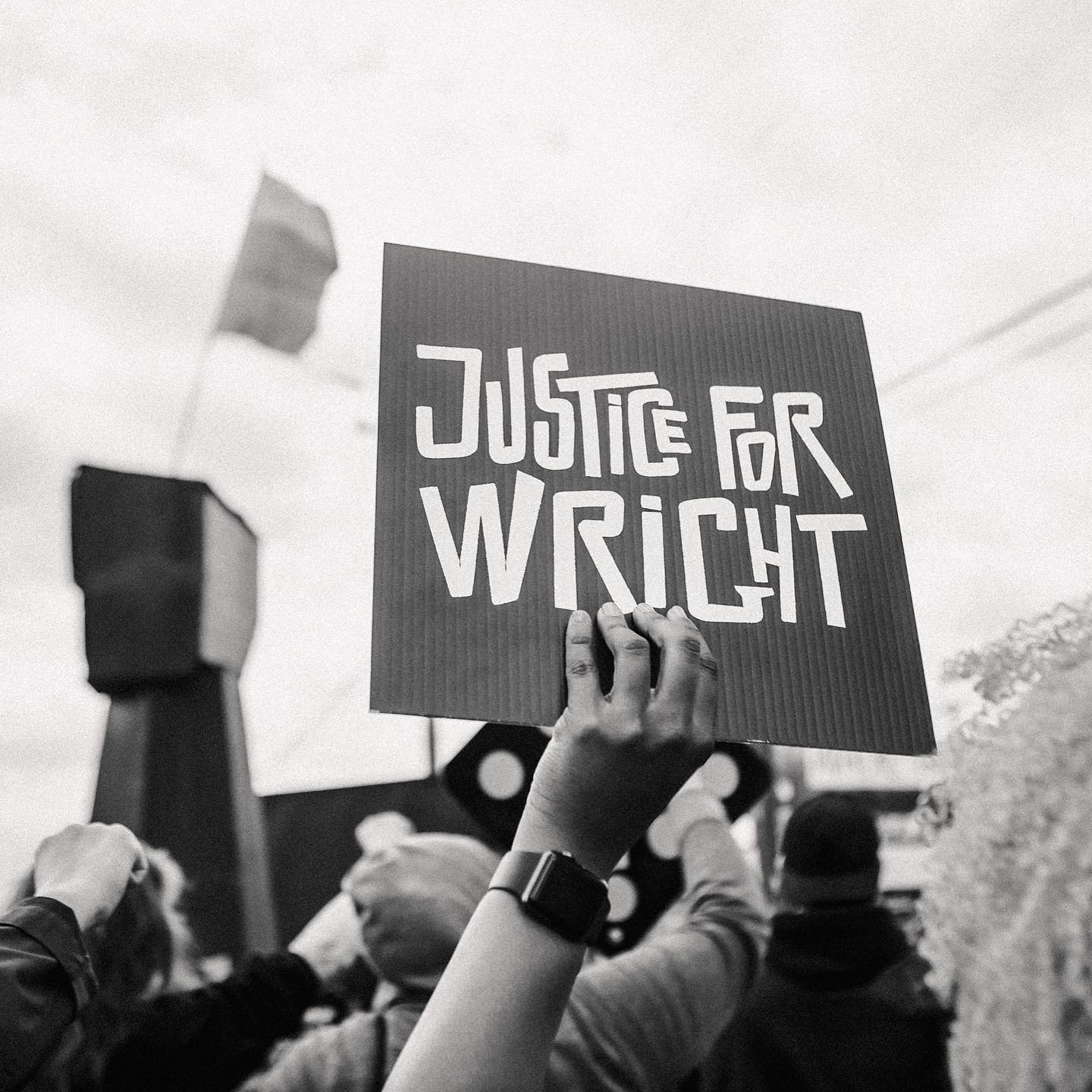 Person holding sign with words "Justice for Wright"